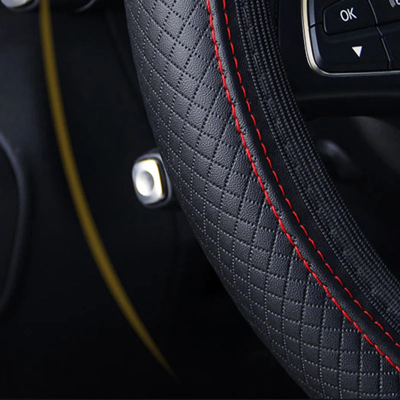 Zoom sur la texture antidérapante et la couture rouge du couvre-volant Dryyver Pure Linea